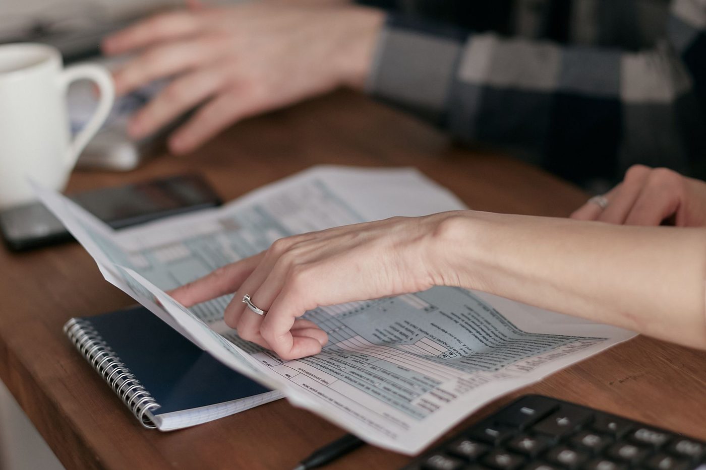 Church leaders reviewing financial papers together at a wooden table